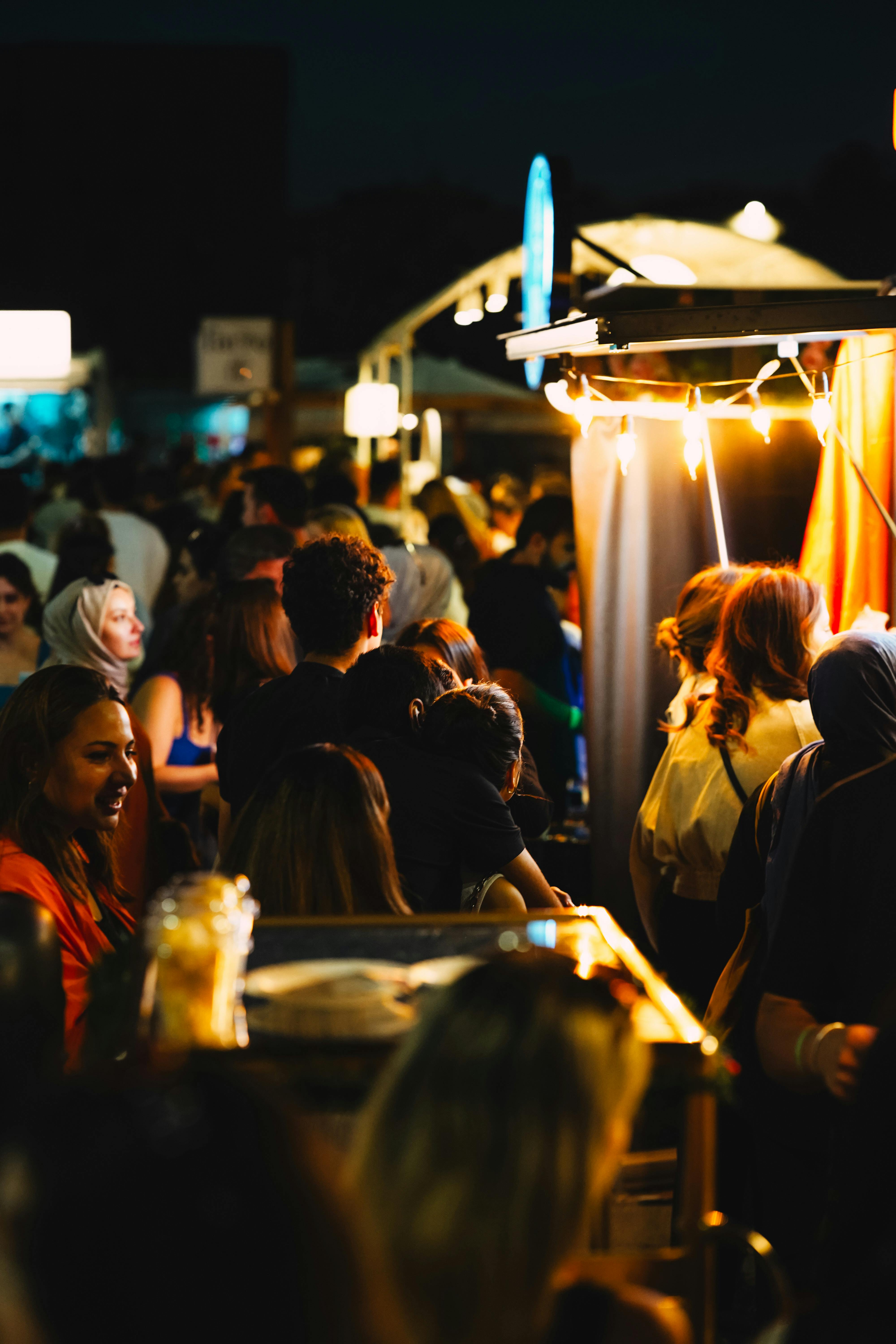 A night market crowd under warm lights